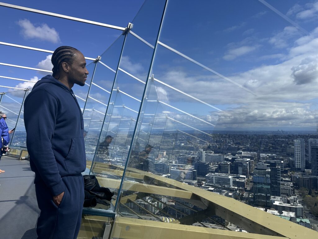 Robert Johnson looks out over Seattle from the glass windows of the Space Needle.
